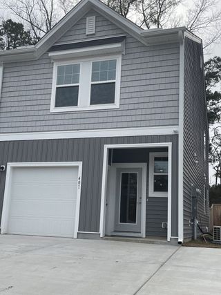 A modern gray home with sleek design and garage in Dawson Branch by Starlight Homes (Summerville, SC).