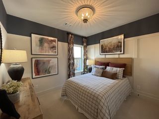 Model Home A luxurious primary bedroom with vaulted ceilings, warm decor, and a statement chandelier in Solterra by David Weekley Homes (Mesquite, TX).