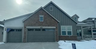A charming modern home with a stone and siding facade in Macanta: The Grand Collection by Lennar (Castle Rock, CO).