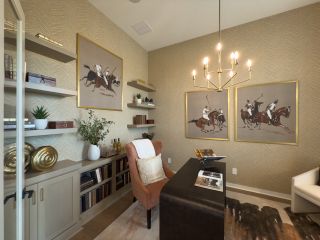 Model Home A sophisticated home office with chic art, elegant shelving, and modern lighting.