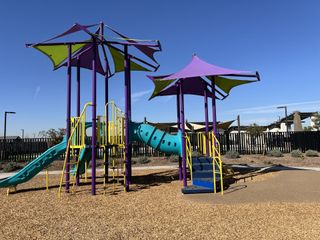 A vibrant playground with colorful slides and structures in Avion: Horizon by Lennar in Goodyear, AZ.