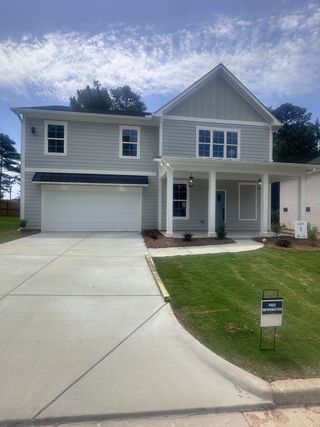 Street view A modern gray two-story home with a welcoming porch in Creekside by MacBuilt Homes (Decatur, GA).
