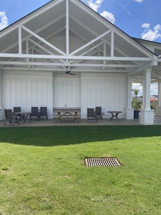 A charming pavilion with seating and a lush lawn at Hewing Farms by Mungo Homes (Summerville, SC).