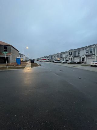 Street view A charming street with modern homes and streetlights in Astonia: Chateau at Astonia by Lennar, located in Davenport, FL.