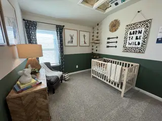A cozy nursery with safari-themed decor, featuring a crib, patterned curtains, and playful wall art.
