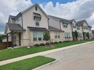 Street view Charming townhomes with modern exteriors and landscaped yards in Lake Parc Village Townhomes by Veralux Homes (Fort Worth, TX).