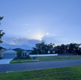 Charming suburban home with manicured lawn under a serene sky in Double Branch by Pulte Homes, Middleburg, FL.