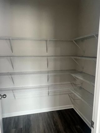 Spacious pantry with multiple wire shelves, perfect for organizing kitchen essentials and storage.