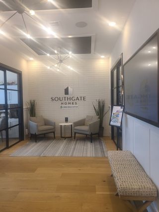 A welcoming office space featuring modern lighting, cozy seating, and stylish decor.