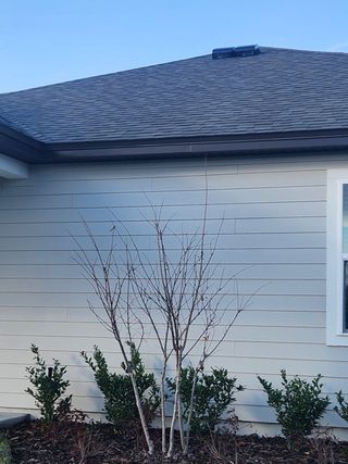 A charming home with a light gray exterior and new roof in Jennings Farm by LGI Homes (Middleburg, FL).