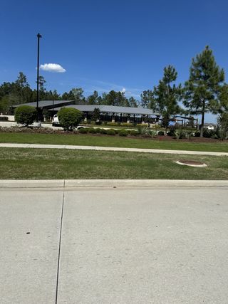 Modern community center with sleek design in Mavera by Meritage Homes, surrounded by lush greenery (Conroe, TX).