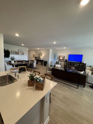 An open-concept living space with a sleek kitchen island, cozy seating, and modern accents.