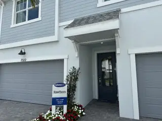 Charming modern home with gray siding and double garage in Forest by Mattamy Homes, Lake Worth, FL.