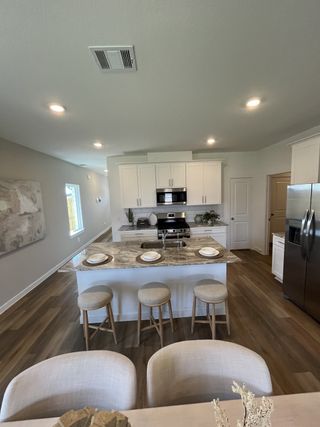 A modern kitchen with a marble island, sleek cabinetry, and stainless steel appliances, creating a cozy and stylish space.