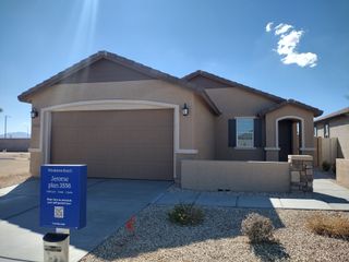 A charming tan stucco home with a two-car garage in Windstone Ranch by Lennar (Surprise, AZ).