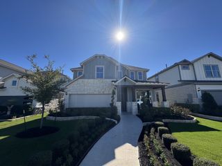 Street view A beautiful stone and siding home with pristine landscaping in Santa Rita Ranch by Pulte Homes (Liberty Hill, TX).