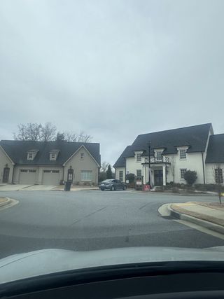 Street view Charming homes with elegant exteriors at Cottages at Noble Village by Seed Capital Investments, LLC (Lilburn, GA).
