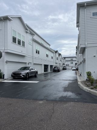 Modern townhomes with sleek white siding in Westshore Crossing by David Weekley Homes, located in Tampa, FL.