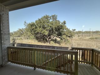 A serene backyard view featuring a wooden deck and rustic landscape, perfect for enjoying nature.