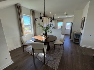 Model Home Cozy dining nook with a round table, sleek lighting, and natural light enhancing the inviting setting.