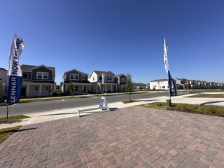 Modern homes line a sunny street in Bronson's Ridge by Lennar in Apopka, FL.