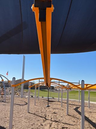 Community Amenities A vibrant playground with modern equipment and shaded areas in The Lakes at Rancho El Dorado by Brightland Homes (Maricopa, AZ).