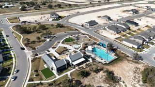 Community Amenities Aerial view of community amenities at Nolina 60' by Perry Homes in Georgetown, TX, showcasing a pool and recreational areas.