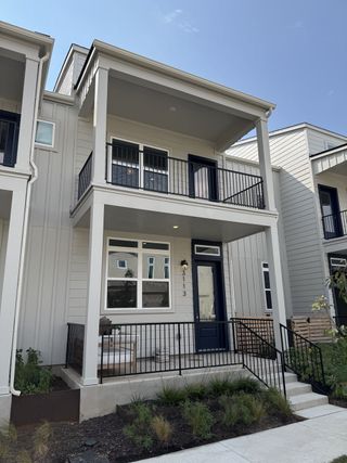 Street view A modern two-story home with a spacious balcony and sleek design in Mueller 11 - 22.5 X 90 Row Home by Lennar (Austin, TX).