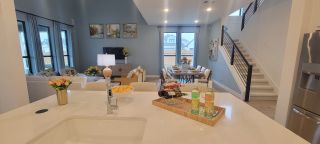 This spacious living and dining area combines comfort and style with clean lines and beautiful furniture.