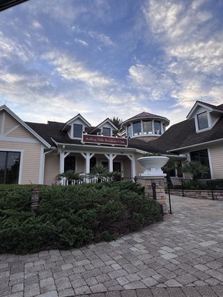 Street view A charming clubhouse with a classic design in Shadow Crest at Rolling Hills by Adams Homes (Green Cove Springs, FL).