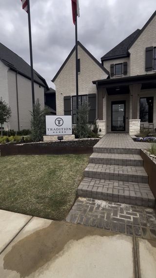 Street view Elegant brick home with lush landscaping at Lakewood at Brookhollow – 60' by Tradition Homes, Prosper, TX.