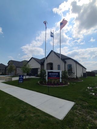 Charming brick home with manicured lawn in Anna Town Square by Pulte Homes, Anna, TX.