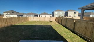 Model Home A spacious fenced backyard with new sod in Roosevelt Heights by Starlight Homes, San Antonio, TX.