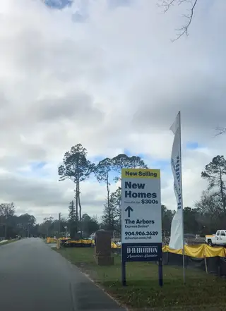 A community sign promoting new homes starting from the $300s in a developing neighborhood at The Arbors by D.R. Horton (Jacksonville, FL) 