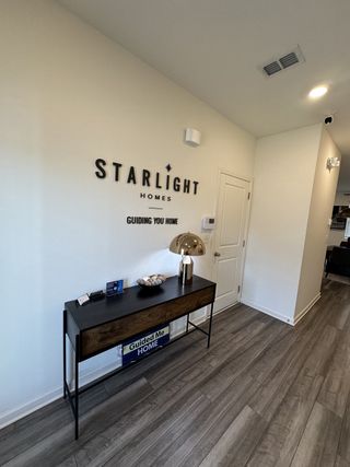 A welcoming entryway with sleek flooring, a modern console table, and stylish decor accents.