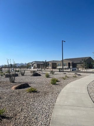 A serene desert community with modern homes and landscaped paths in Silva Farms by Meritage Homes (Goodyear, AZ).
