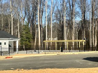 Model Home A peaceful community space featuring a pergola and fenced-in area, perfect for outdoor gatherings in Sherri Downs by Lennar (Angier, NC).