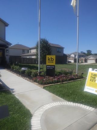 A manicured garden and inviting entrance at Glendale Lakes North by KB Home in Arcola, TX.