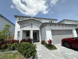 Elegant two-story home with stone accents and lush landscaping in Salerno by Lennar (Richmond West, FL).