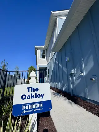 A modern blue home with sleek siding in Corsair by D.R. Horton (Middleburg, FL).