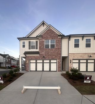 Street view A charming brick townhouse with modern accents in The Towns at Auburn Station West by Chafin Communities (Auburn, GA).