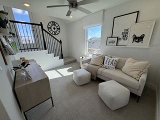 Model Home A cozy upstairs loft with natural light, modern décor, and a built-in reading nook, perfect for relaxation or casual entertaining.