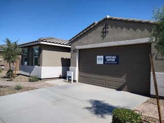 Street view A contemporary home with stone accents and desert landscaping in Paloma Creek - Reserve Series by Meritage Homes (Surprise, AZ).
