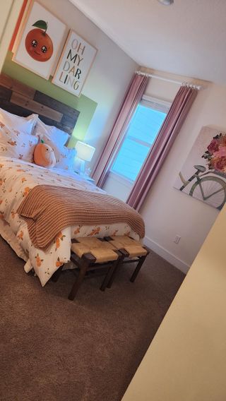 A playful and cheerful bedroom featuring soft pink drapes, citrus-themed bedding, and adorable wall art for a charming vibe.

