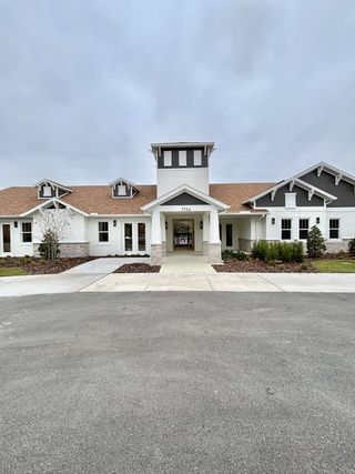 A charming modern home with stone accents and dormer windows in Naples Village at Verona I by KB Home (Titusville, FL).