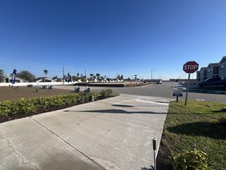 A developing community with wide streets and tidy landscaping in Brentwood Townhomes by D.R. Horton (Davenport, FL).