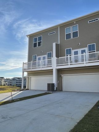 Modern three-story townhome with spacious balconies in Recess Pointe Townhomes by DRB Homes, Moncks Corner, SC.
