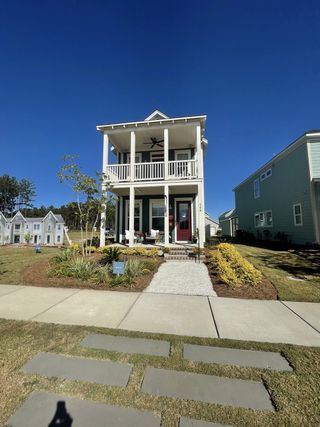 A charming two-story home with a welcoming porch in Nexton - Midtown by Saussy Burbank (Summerville, SC).