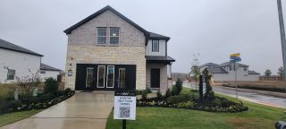 Charming stone and brick home with manicured landscaping in Meadows at Hennersby Hollow 40's by Ashton Woods (San Antonio, TX).