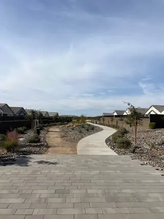 Community Amenities A scenic walkway with desert landscaping in Radiance At Superstition Vistas by D.R. Horton (Apache Junction, AZ).